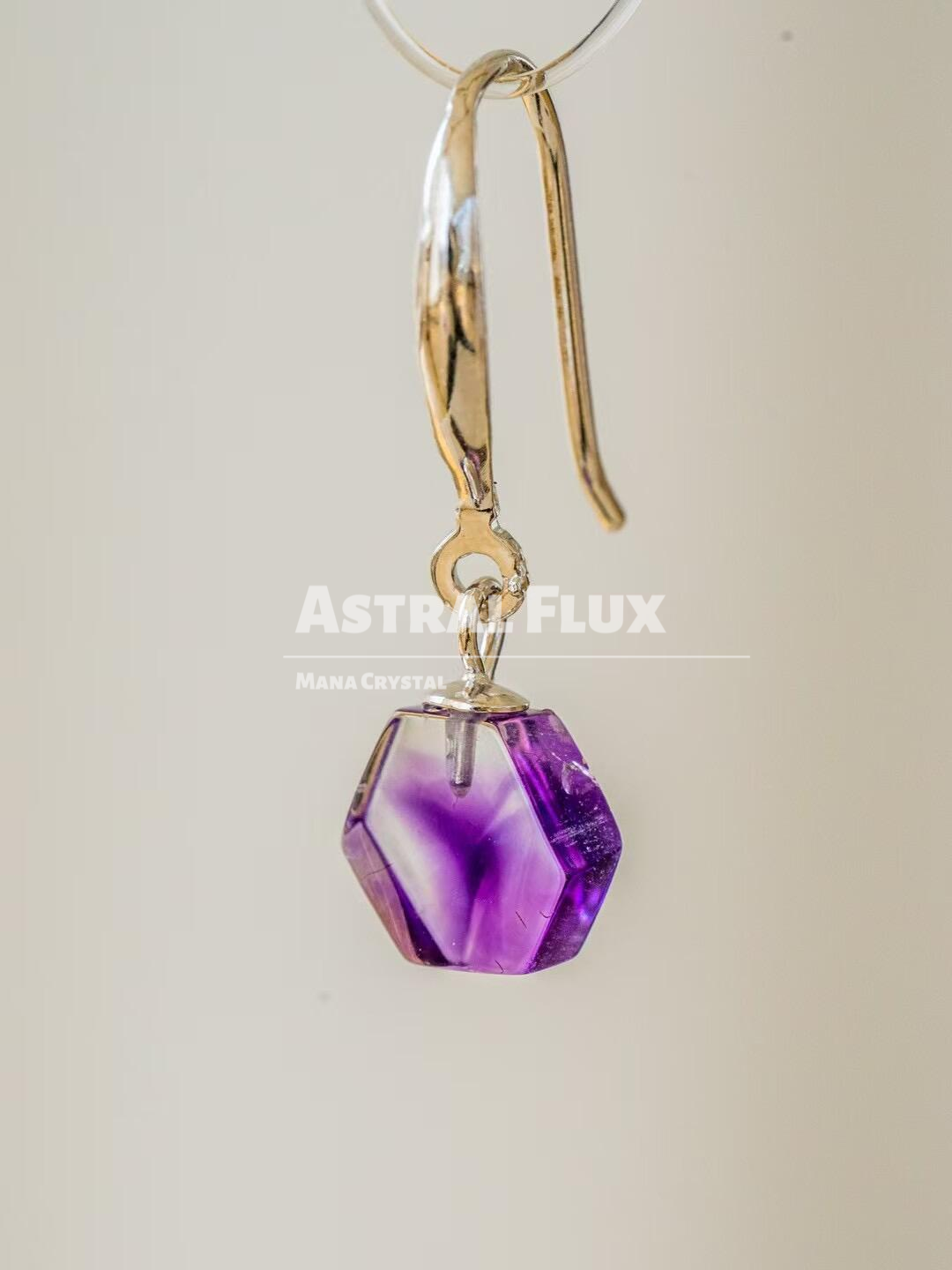 Purple crystal earrings with cosmic blessings in the ears