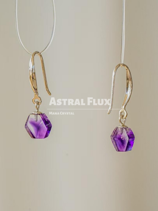 Purple crystal earrings with cosmic blessings in the ears